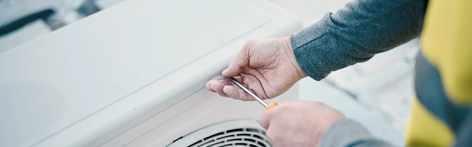 A man doing air conditioner maintenance work